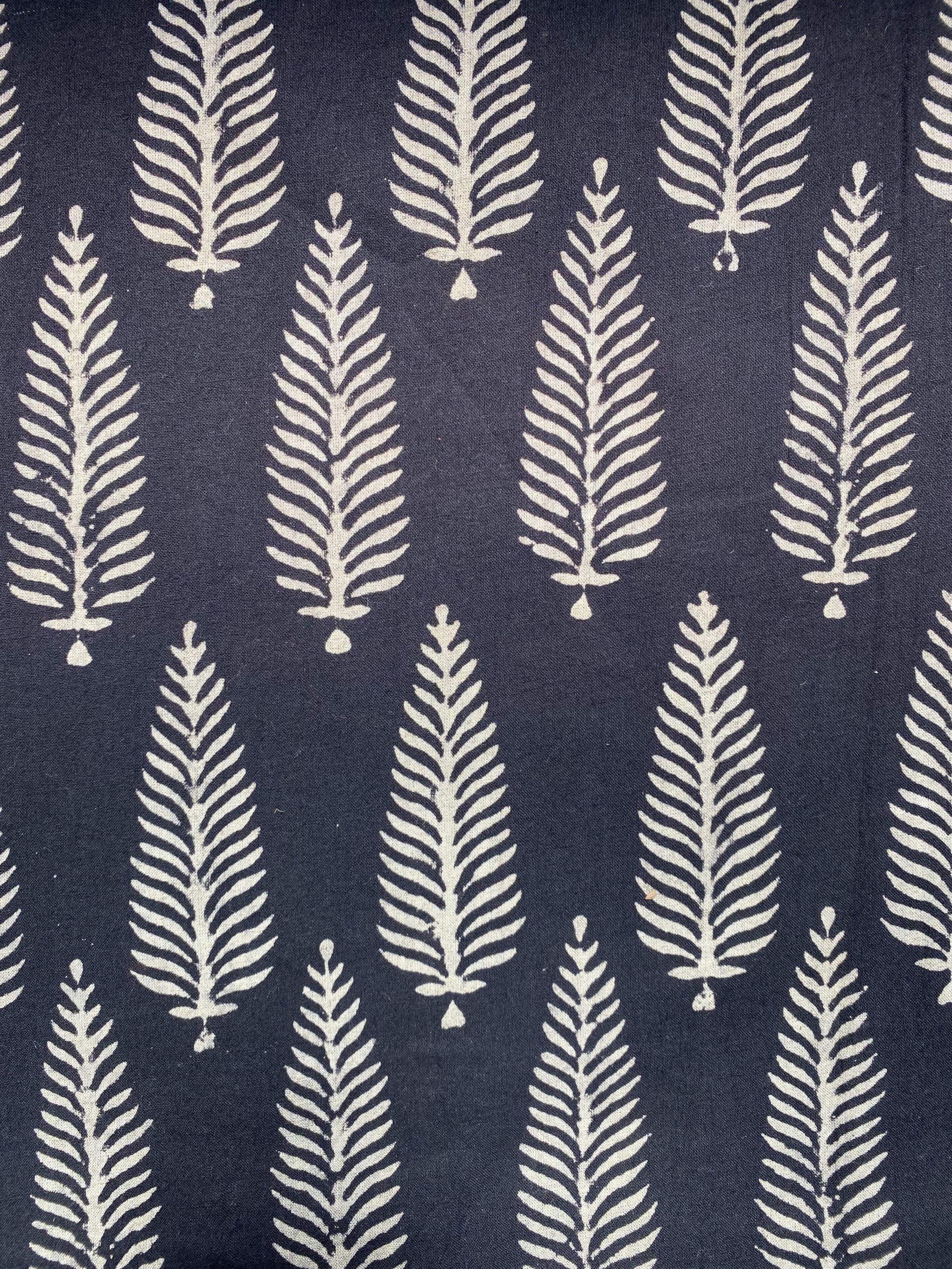Navy fabric with repeating white fern motifs in vertical columns