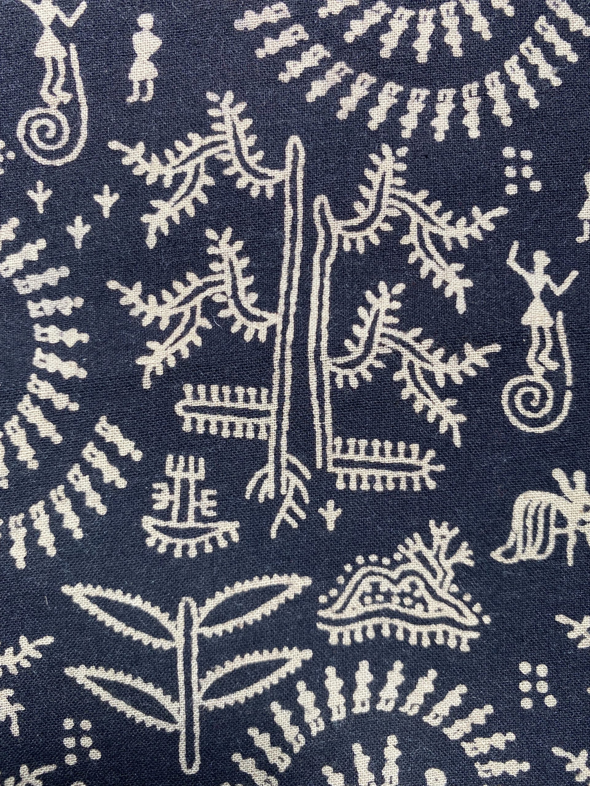 Decorative textile pattern: white botanical and geometric motifs on a dark blue background